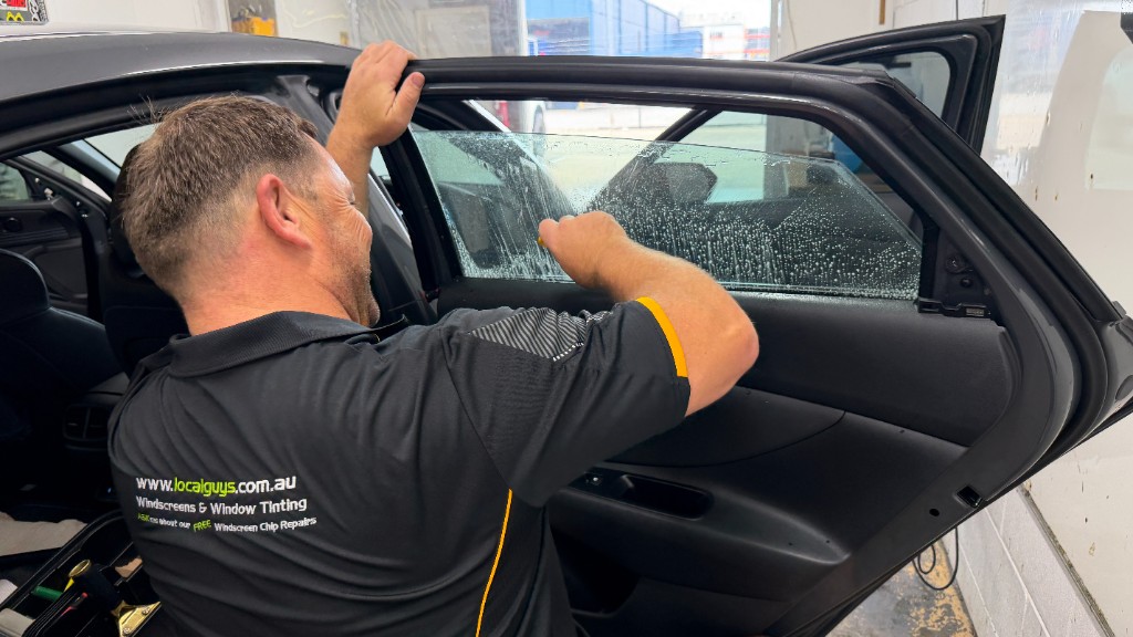 Local Guys technician installing automotive window tint
